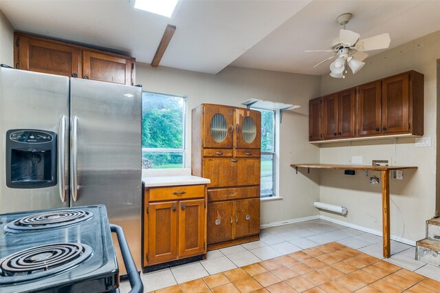 1455 N Joe Wilson Rd, Cedar Hill, TX 75104 - kitchen with stainless steel refrigerator with ice dispenser, a ceiling fan, light countertops, brown cabinetry, and light tile patterned floors