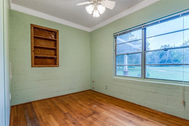 1455 N Joe Wilson Rd, Cedar Hill, TX 75104 - empty room featuring hardwood / wood-style flooring, ceiling fan, a textured ceiling, and crown molding