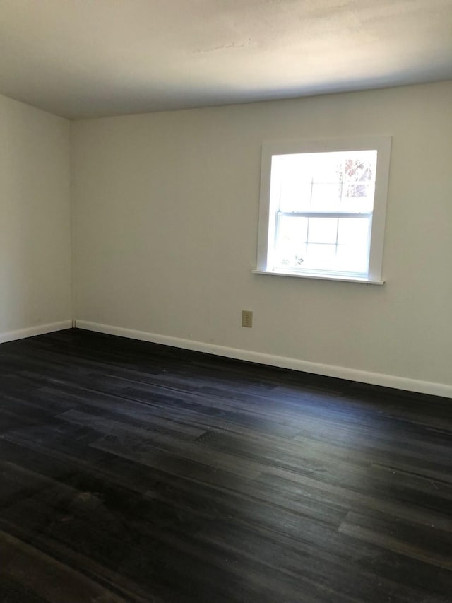 132 Keck St, Nocona, TX 76255 - empty room featuring baseboards and dark wood-type flooring