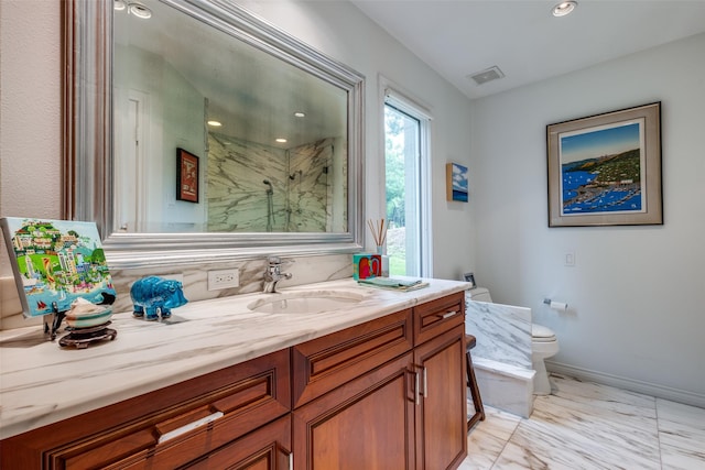 full bath with marble finish flooring, toilet, a marble finish shower, vanity, and baseboards