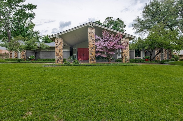 mid-century inspired home with a front lawn and stone siding