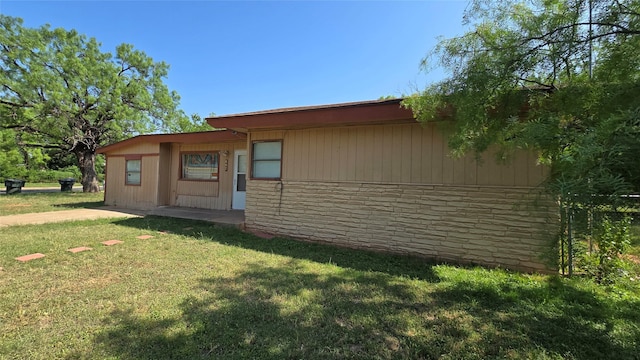 897 Sunset Dr, Abilene, TX 79605 - view of side of property with a yard and stone siding