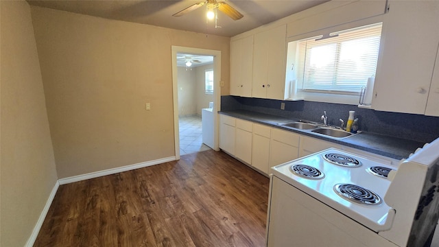 897 Sunset Dr, Abilene, TX 79605 - kitchen with electric range, a sink, ceiling fan, dark countertops, and wood finished floors