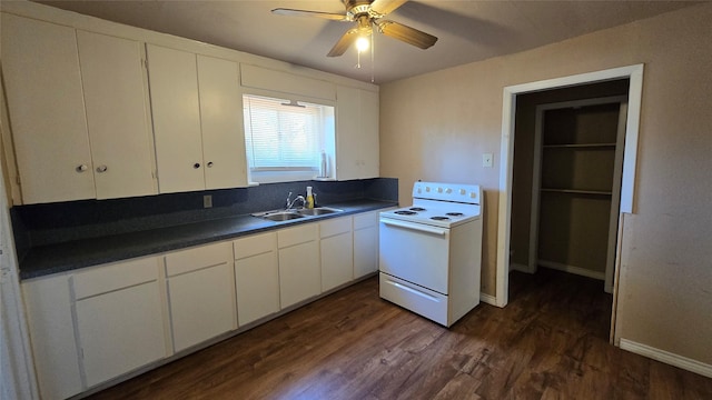 897 Sunset Dr, Abilene, TX 79605 - kitchen featuring electric stove, a sink, dark countertops, and white cabinetry