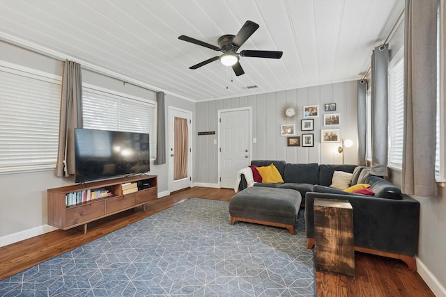 living room with a ceiling fan, wood finished floors, baseboards, and wood ceiling