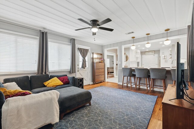 living room featuring a ceiling fan and wood finished floors