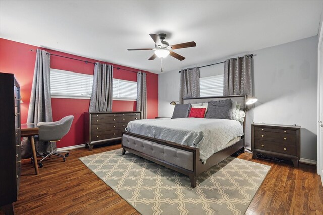 bedroom with wood finished floors, a ceiling fan, and baseboards