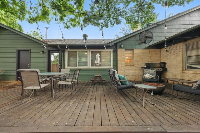 wooden terrace featuring outdoor dining area and grilling area