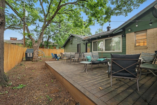 deck featuring outdoor lounge area, a fenced backyard, and outdoor dining space