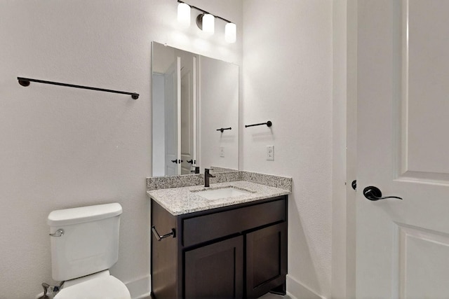 bathroom featuring toilet and vanity