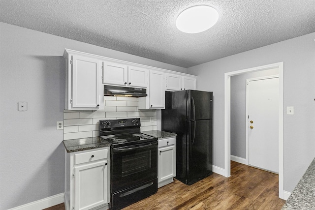 kitchen featuring black appliances, under cabinet range hood, white cabinetry, decorative backsplash, and baseboards