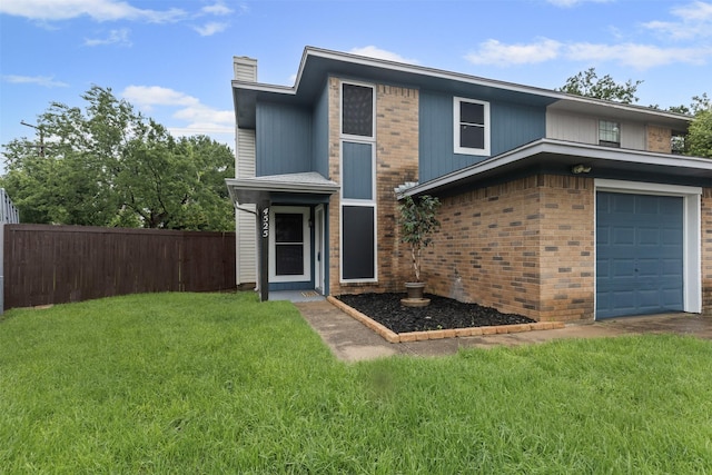 view of front of property with an attached garage, a chimney, and brick siding