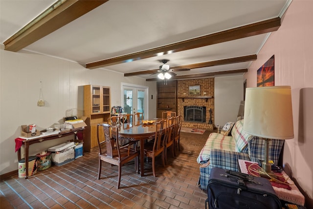 201 Sunset Dr, Fairfield, TX 75840 - dining room with beam ceiling, brick floors, a fireplace, a ceiling fan, and french doors