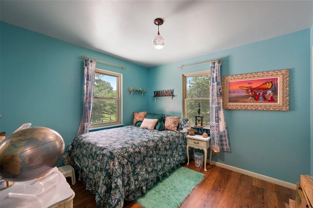 201 Sunset Dr, Fairfield, TX 75840 - bedroom featuring multiple windows, wood finished floors, and baseboards