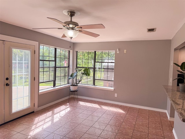 3836 Farm Road 196 N, Paris, TX 75462 - unfurnished dining area with plenty of natural light, a ceiling fan, and baseboards