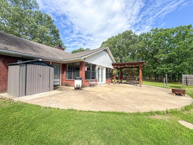 3836 Farm Road 196 N, Paris, TX 75462 - rear view of property with an outdoor fire pit, brick siding, a patio, and a storage shed