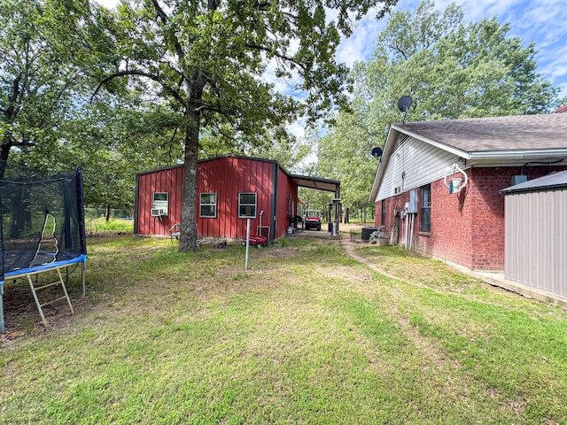 3836 Farm Road 196 N, Paris, TX 75462 - view of grassy yard with a trampoline and an outdoor structure