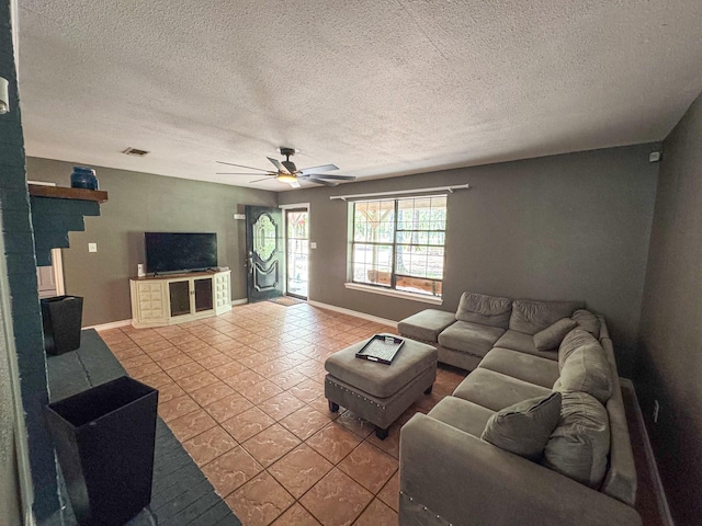 3836 Farm Road 196 N, Paris, TX 75462 - living room featuring a textured ceiling, tile patterned flooring, a ceiling fan, and baseboards