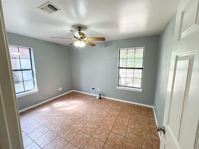 3836 Farm Road 196 N, Paris, TX 75462 - tiled empty room featuring ceiling fan, baseboards, and a textured ceiling