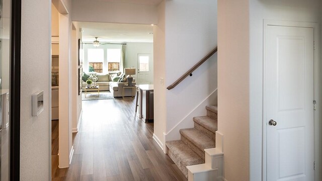 hallway with dark wood-style flooring and stairs