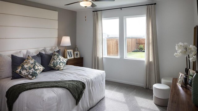 bedroom featuring carpet, baseboards, and a ceiling fan
