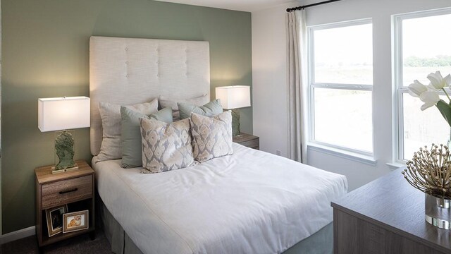bedroom featuring dark colored carpet