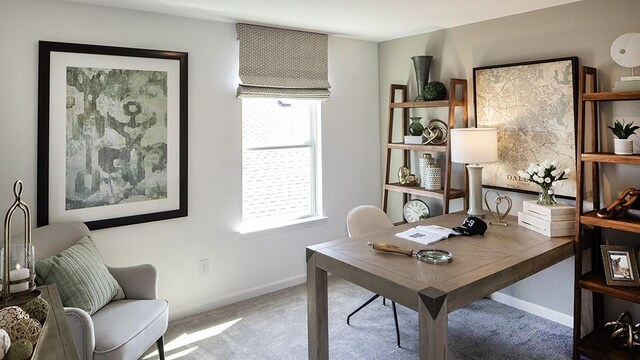 carpeted home office featuring baseboards