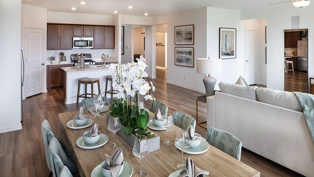 dining area with recessed lighting, dark wood-style flooring, and baseboards