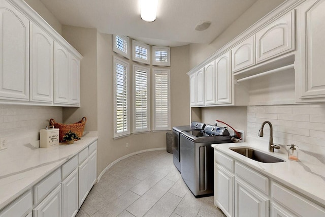 3001 Pecan Grove Ln, Celina, TX 75078 - clothes washing area with washing machine and dryer, cabinet space, baseboards, and light tile patterned floors