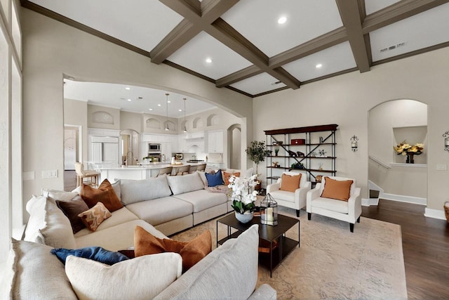 3001 Pecan Grove Ln, Celina, TX 75078 - living area featuring arched walkways, beamed ceiling, baseboards, coffered ceiling, and dark wood-style floors