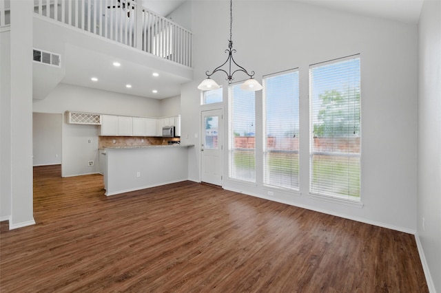 2763 Beverly Dr, Rockwall, TX 75032 - unfurnished dining area featuring high vaulted ceiling, dark wood-type flooring, baseboards, a chandelier, and recessed lighting