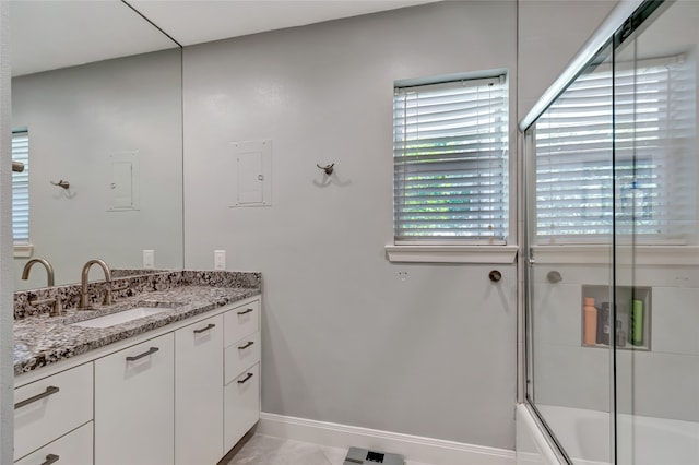 6522 Willow Ln, Dallas, TX 75230 - bathroom featuring vanity, bath / shower combo with glass door, and baseboards