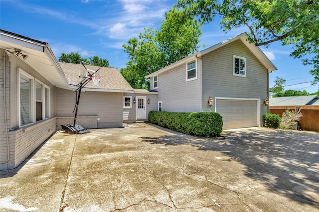 6522 Willow Ln, Dallas, TX 75230 - view of home's exterior with a garage, driveway, and brick siding