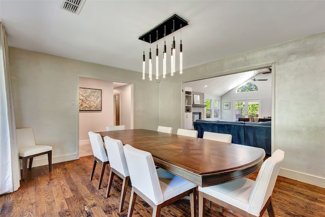 6522 Willow Ln, Dallas, TX 75230 - dining room with vaulted ceiling, wood finished floors, ceiling fan, baseboards, and a fireplace