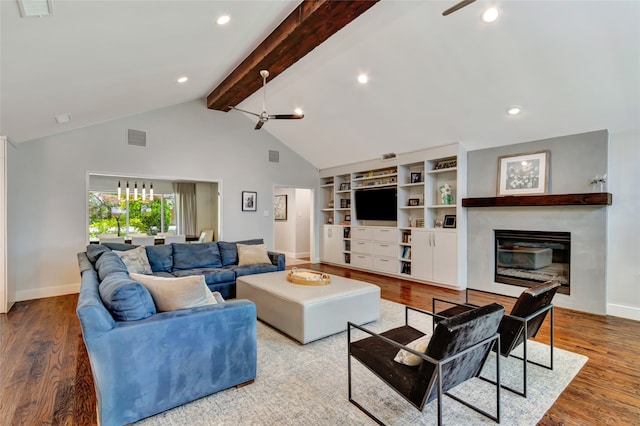 6522 Willow Ln, Dallas, TX 75230 - living room featuring baseboards, a glass covered fireplace, beam ceiling, wood finished floors, and recessed lighting