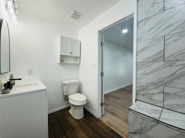 2719 S 27th, Waco, TX 76706 - bathroom featuring wood finished floors, toilet, vanity, and baseboards