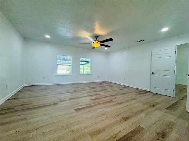 2719 S 27th, Waco, TX 76706 - spare room with wood finished floors, a textured ceiling, a ceiling fan, baseboards, and recessed lighting