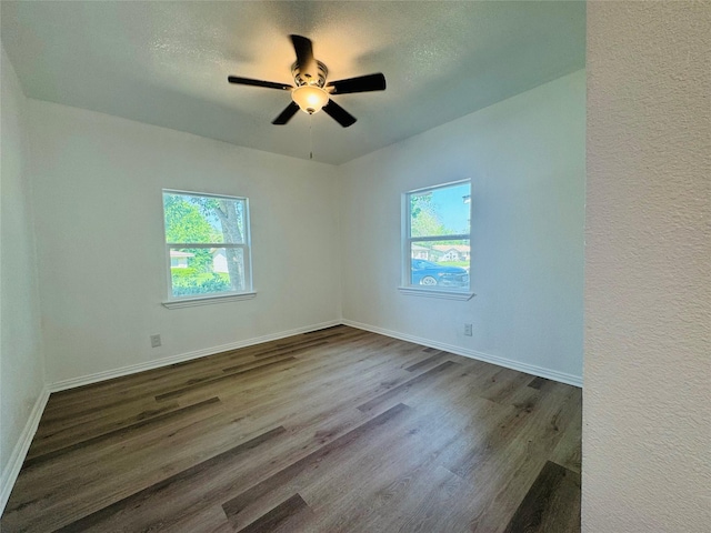 2719 S 27th, Waco, TX 76706 - empty room featuring dark wood-style floors, ceiling fan, baseboards, and a textured ceiling