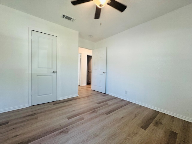 2719 S 27th, Waco, TX 76706 - unfurnished bedroom featuring wood finished floors, baseboards, and a ceiling fan