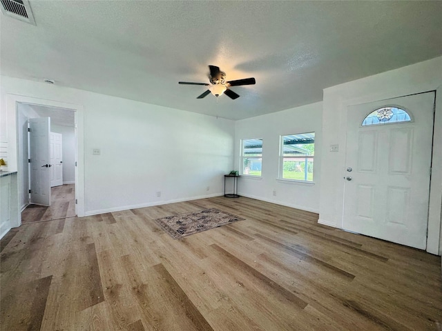 2719 S 27th, Waco, TX 76706 - entrance foyer with wood finished floors, ceiling fan, baseboards, and a textured ceiling