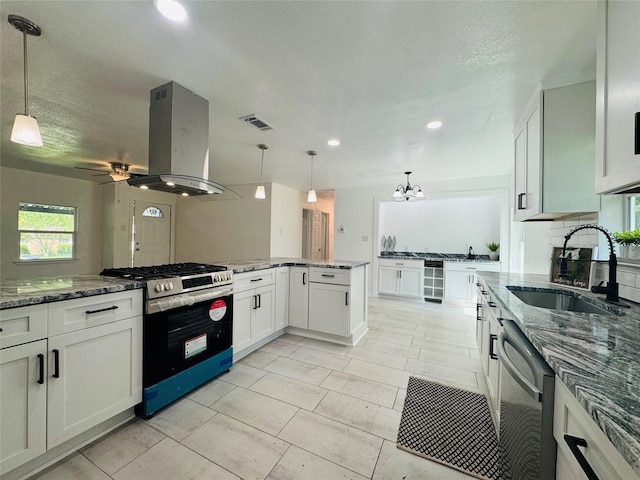 2719 S 27th, Waco, TX 76706 - kitchen with stainless steel appliances, island range hood, a sink, wine cooler, and white cabinetry