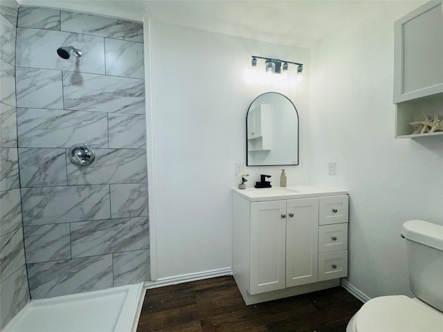 2719 S 27th, Waco, TX 76706 - full bathroom featuring toilet, wood finished floors, and tiled shower