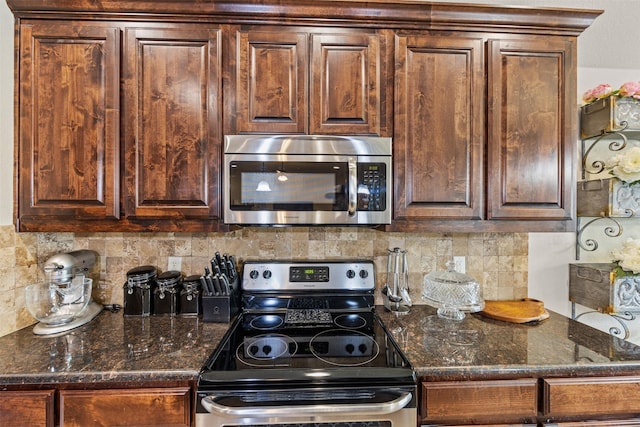 2725 Buffalo Run, Burleson, TX 76028 - kitchen with appliances with stainless steel finishes, decorative backsplash, dark stone countertops, and dark brown cabinets