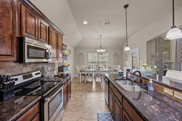 2725 Buffalo Run, Burleson, TX 76028 - kitchen with appliances with stainless steel finishes, a sink, vaulted ceiling, a chandelier, and hanging light fixtures