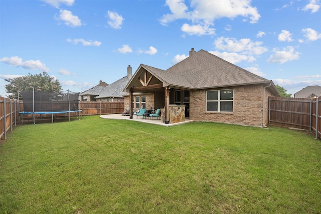2725 Buffalo Run, Burleson, TX 76028 - back of house with a trampoline, a patio area, brick siding, roof with shingles, and a chimney