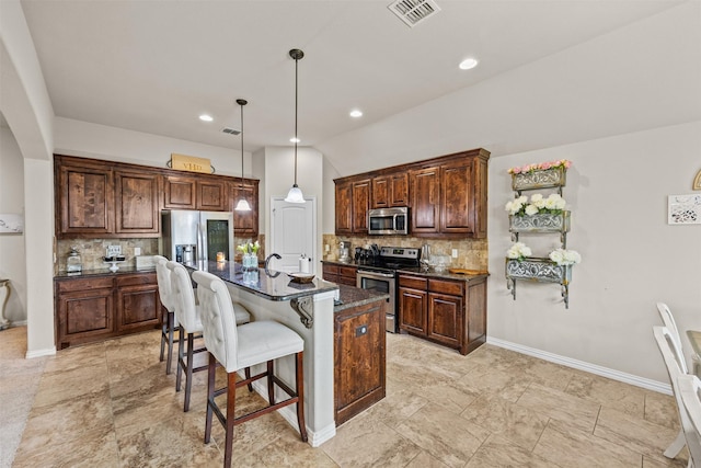2725 Buffalo Run, Burleson, TX 76028 - kitchen with stainless steel appliances, backsplash, a breakfast bar, and hanging light fixtures