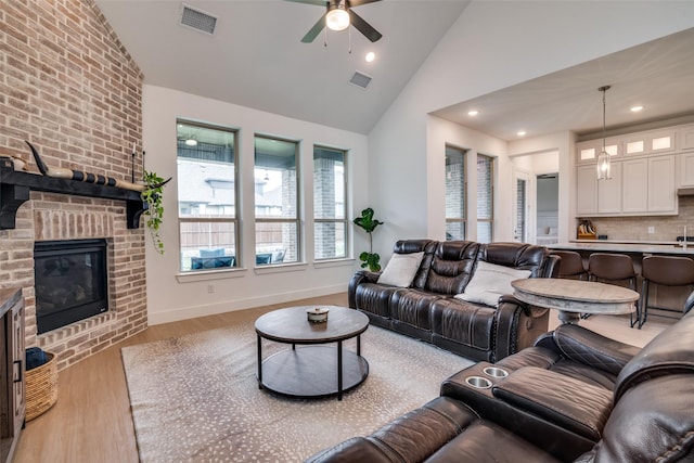 2309 Albion Way, Forney, TX 75126 - living area with ceiling fan, light wood-style floors, a fireplace, high vaulted ceiling, and recessed lighting