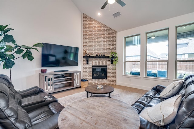 2309 Albion Way, Forney, TX 75126 - living area with ceiling fan, vaulted ceiling, wood finished floors, and a fireplace