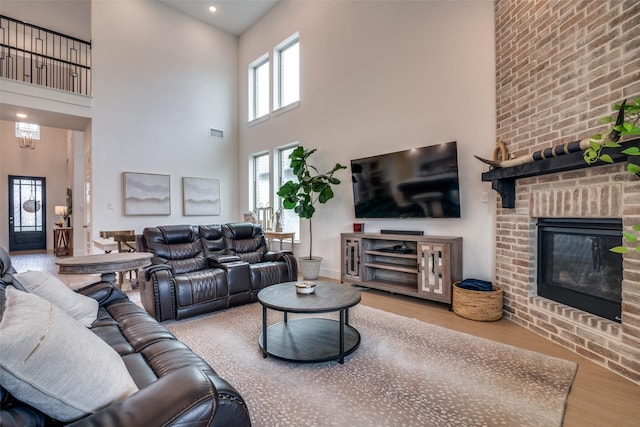 2309 Albion Way, Forney, TX 75126 - living room featuring wood finished floors, a high ceiling, a fireplace, and recessed lighting