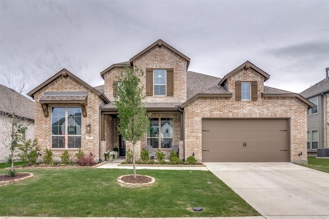 2309 Albion Way, Forney, TX 75126 - view of front facade featuring brick siding, a front lawn, a shingled roof, and driveway